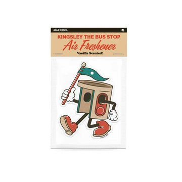 An air freshener shaped like a bus stop with arms and legs walking and holding a flag. There is a product label attached to the top.