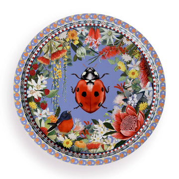 A round tin tray illustrated with a lady bug beetle in the middle surrounded by a border of flowers.