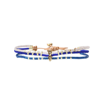 Set of three bracelets with blue, gold, and white beads on a white background.