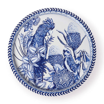 A round tin tray illustrated with birds and flowers in blue and white.