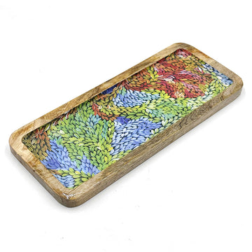 A wooden rectangular tray printed with artwork by Patricia Multa inside.