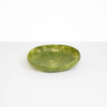 A shallow bowl in olive green resin.