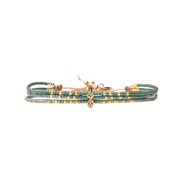 Green beaded bracelet with gold accents on a white background.