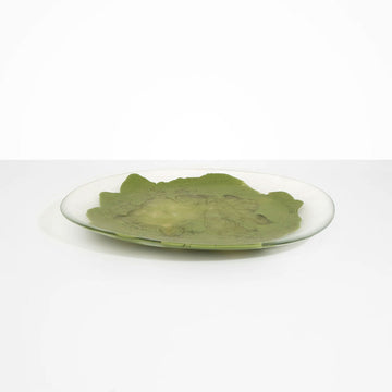 A large round platter in clear and olive green resin.