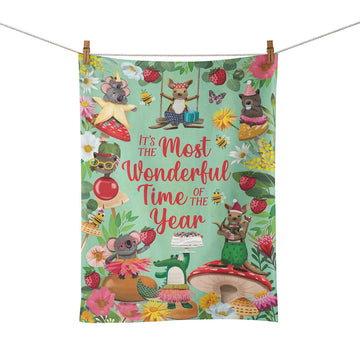 A tea towel illustrated with Australian animals and the text 'It's the Most Wonderful Time of the Year' in the middle.
