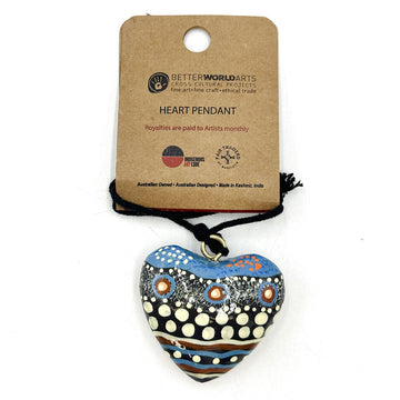 A heart shaped pendant painted with artwork by Bianca Gardiner Dodd attached to a black cord and wrapped around a brown card with product information.