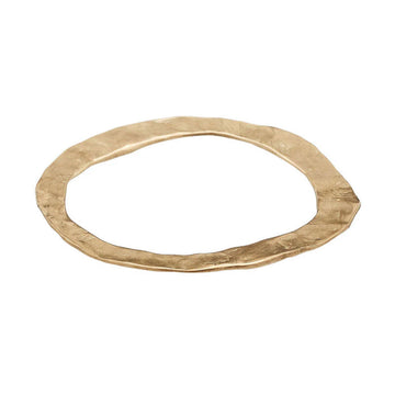 A flat style bangle in bronze in an irregular round shape.