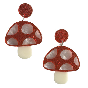 A pair of stud drop earrings with red glitter circles at the top and mushrooms hanging below made from acrylic. 