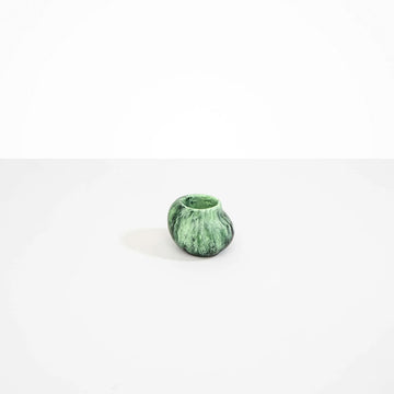 A small irregular shaped round vase in moss green resin.