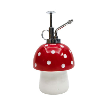 A water mister shaped like a white and red toadstool.