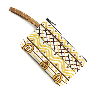 A leather pouch with decorative patterns in yellow on a white background.