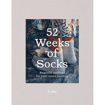 '52 Weeks of Socks' book cover featuring a a close up photo of a person wearing knitted socks with a long floral dress.