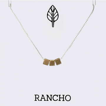 Necklace with gold square pendants on a white background with 'RANCHO' branding.