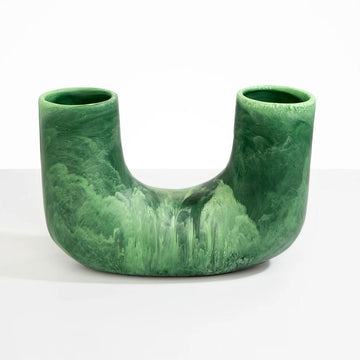 A U shaped vase made from green resin.