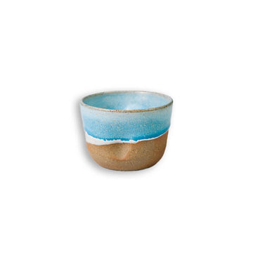 Ceramic cup with blue top and brown bottom on a white background.