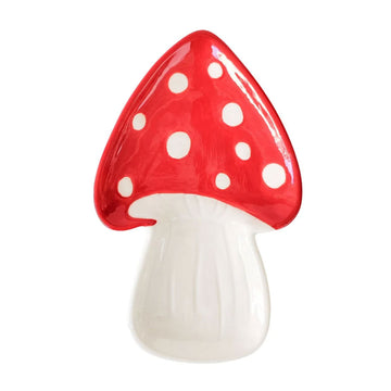 A ceramic plate shaped like a red and white toadstool.
