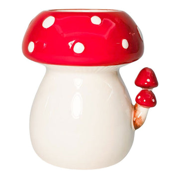 A pot planter shaped like a red and white toadstool.