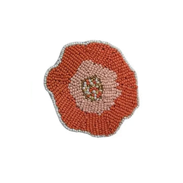 A beaded coaster shaped like a flower.