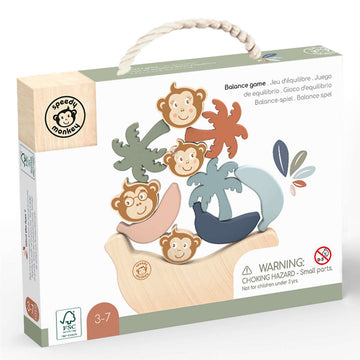 A tall puzzle display of monkey faces, palm trees and banana shapes balancing on top of a large wooden banana.