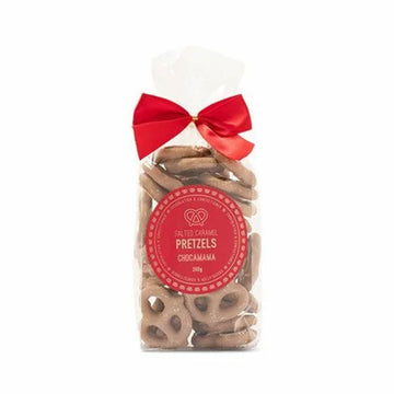 A clear bag filled with caramel covered pretzels tied with a red bow.