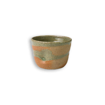 Ceramic cup with earthy tones on a white background.