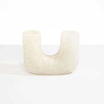 A U shaped vase in a cream coloured resin.