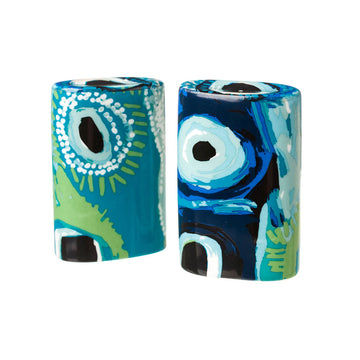 A pair of ceramic salt and pepper shakers printed with artwork by May Wokka in green and blue.