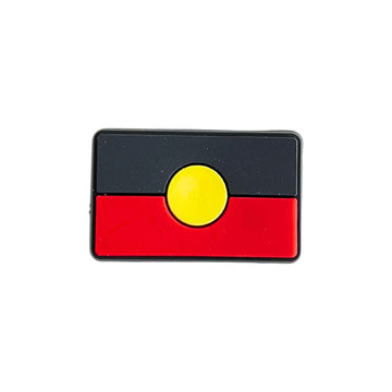 PVC shoe charm shaped and coloured like the Aboriginal flag.