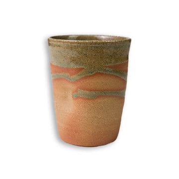 Ceramic cup with earthy tones on a white background.