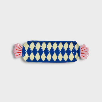 Decorative candy-shaped plate with blue and white checkered pattern on a light gray background.
