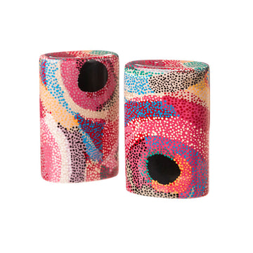 A pair of ceramic salt and pepper shakers printed with artwork by Marianne Burton in red, blue, yellow and black.