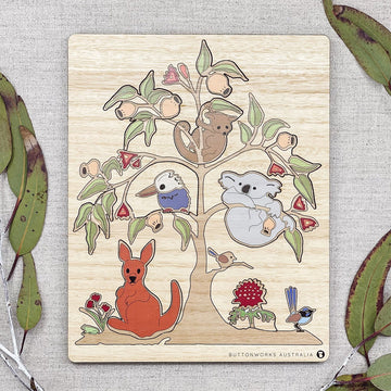 A wooden puzzle in a board shaped like a tree with Australian animals in the tree.