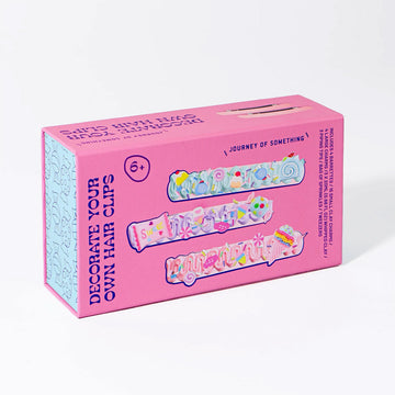 Pink box of 'Decorate Your Own Hair Clips' craft kit on a white background.