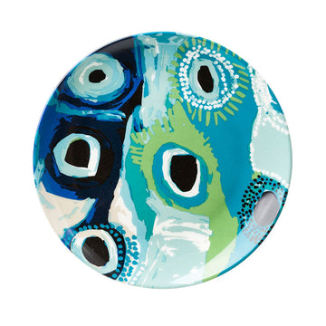 A round ceramic plate printed with artwork by May Wokka in green and blue.