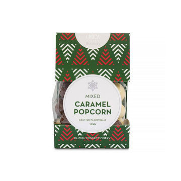 A box with a Christmas theme and the heading 'Mixed Caramel Popcorn' with chocolate pieces visible inside.