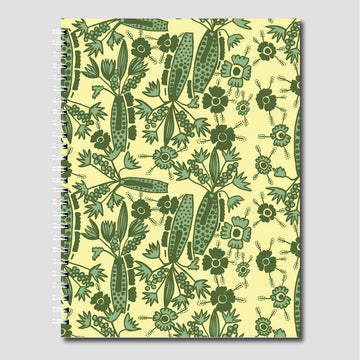A spiral bound journal printed with flowers and plants in green on a yellow background.