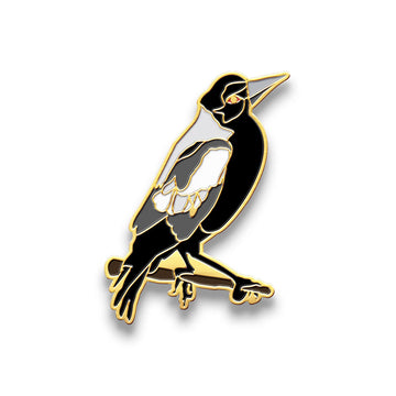 Magpie bird-shaped enamel pin on a white background.
