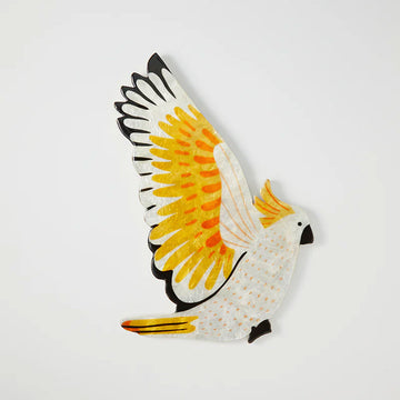 Wall art shaped like a cockatoo with its wings open.
