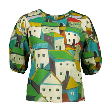 Front view of a women's blouse printed with a design of green houses.