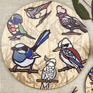 A wooden round trivet illustrated with colourful birds.