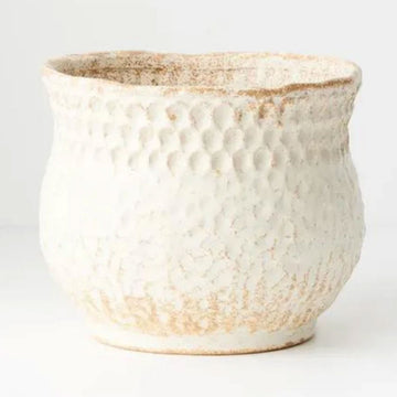 A ceramic pot with a textured design in a cream and light brown colour.