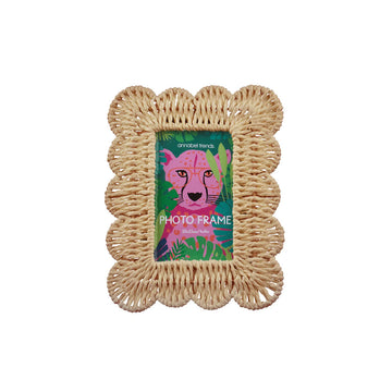 A photo frame with a scalloped shape border in a natural colour.
