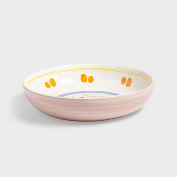 Ceramic bowl with decorative elements on a light gray background.