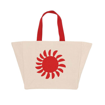 A beige tote bag with a red illustration of the sun and red handles.