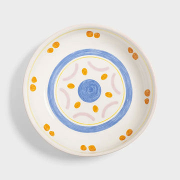 Ceramic bowl with decorative elements on a light gray background.