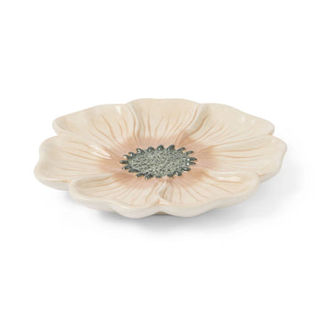 Ceramic dish shaped like a flower on a white background.