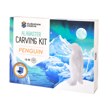 A box titled 'Alabaster Carving Kit Penguin' with a carved white penguin photo against an illustration of icebergs.