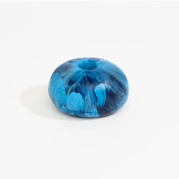 A shallow vase made from blue resin with a swirl design.