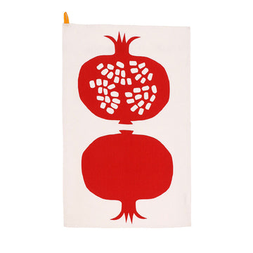 A beige tea towel printed with two large red pomegranates. 