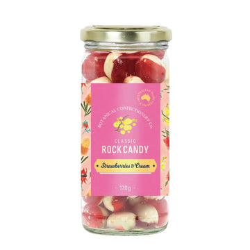 Jar of 'Strawberries & Cream' rock candy with a pink label on a white background.